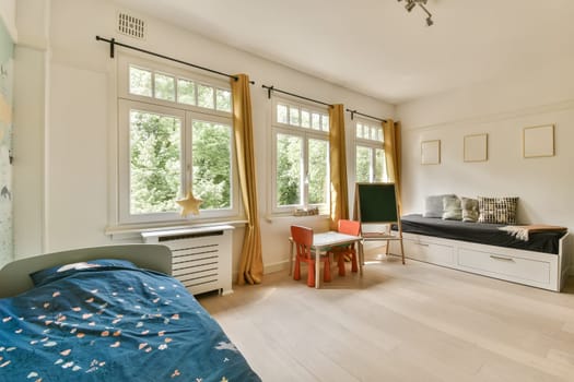 a child's room with a bed, desk, and tv in the corner of the room on the wall