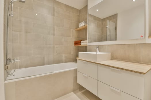 a bathroom with a sink, mirror and bathtub next to the tub in this photo is taken from above