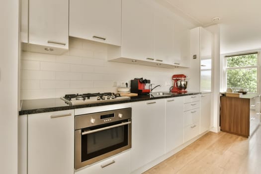 a kitchen with white cupboards and appliances on the counter top in front of the oven, sink and dishwasher