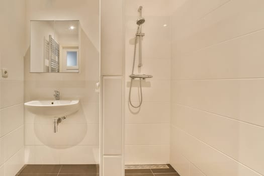 a bathroom with a sink and mirror on the wall next to the shower stall in the room is clean white