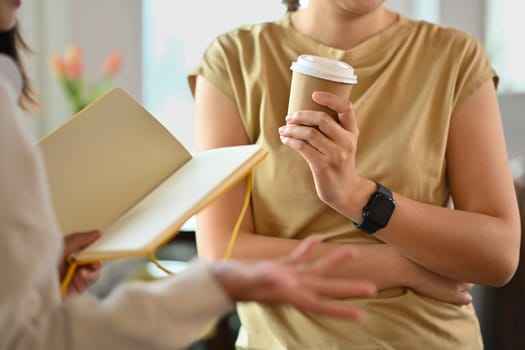 Cropped shot of business colleagues sharing ideas or discussing plans during coffee break.