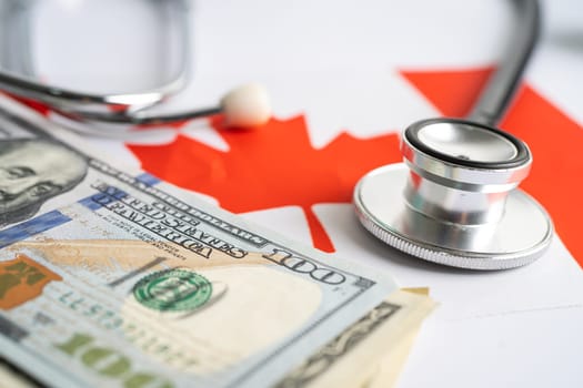 Black stethoscope with US dollar banknotes Canada flag background, Business and finance concept.