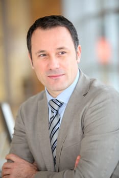 Portrait of smiling businessman with grey suit