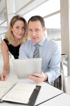 Business people working on electronic tablet