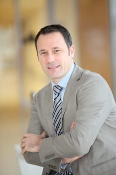 Portrait of smiling businessman with grey suit