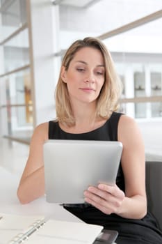 Businesswoman in the office working on electronic tab