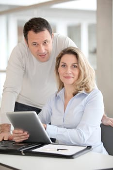 Office workers using electronic tab in the office