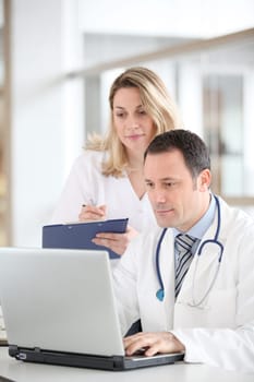 Doctor and nurse working in office