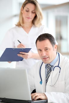 Doctor and nurse working in office