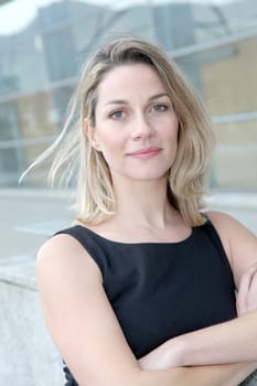 Businesswoman standing outside with arms crossed