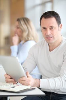 Office worker in the office using electronic tab