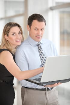 Business partners working on laptop computer