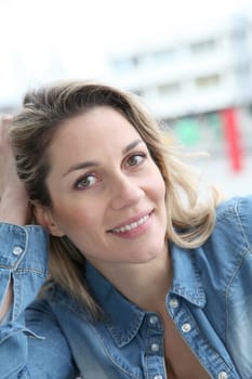 Portrait of beautiful blond woman in town