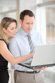 Business partners working on laptop computer