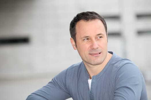 Portrait of hansome man standing in the street