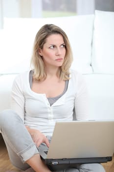Woman with mad look using laptop computer