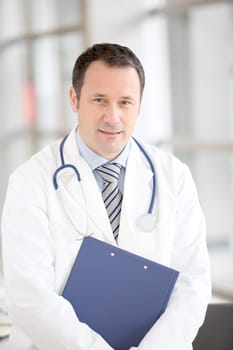 Portrait of doctor standing in hospital corridor