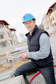 Supervisor using electronic tab on construction site