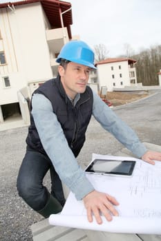 Engineer on construction site with electronic tab