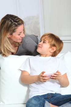 Mother and son playing video game on telephone