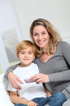 Mother and son playing video game on telephone