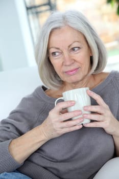 Senior woman drinking hot drink