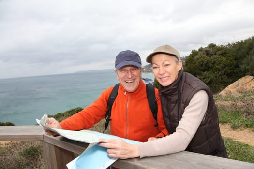 Senior couple looking at map on a rambling day