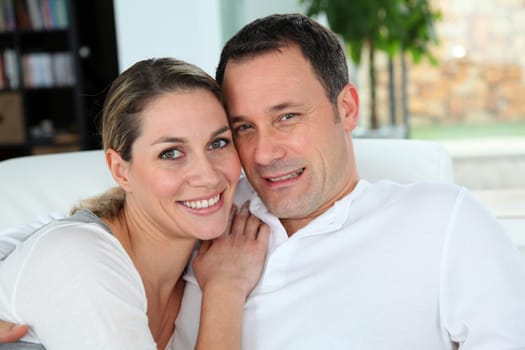 Portrait of couple relaxing at home in sofa