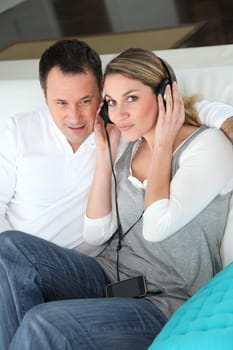 Couple listening to music with headphones