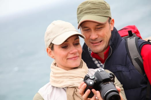 Couple with camera on hiking day