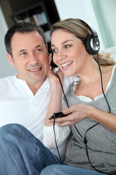 Couple listening to music with headphones