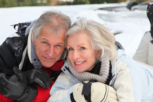Senior couple having fun at ski resort