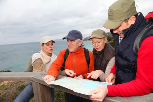Group of people looking at map on a hiking day