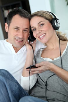 Couple listening to music with headphones
