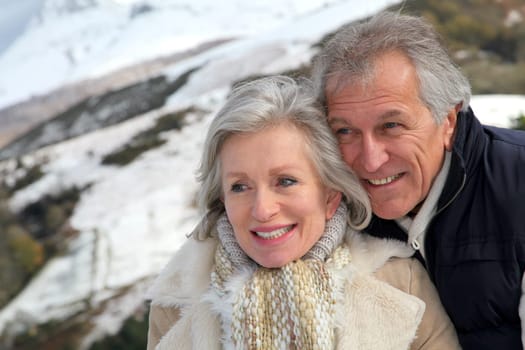 Portrait of happy senior couple at the mountain