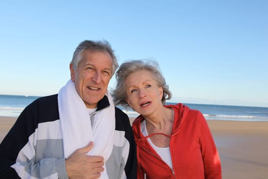 Senior couple exercising by the sea