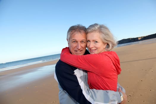 Senior couple exercising by the sea