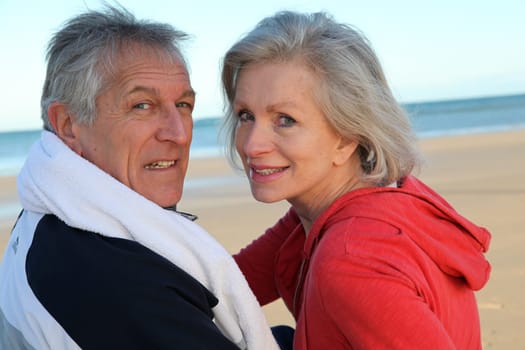 Senior couple exercising by the sea