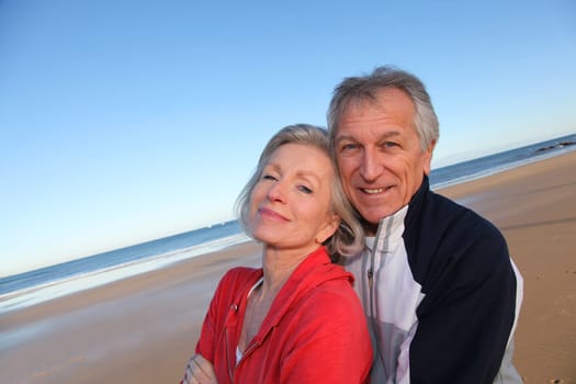 Senior couple exercising by the sea