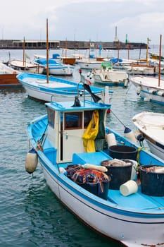 Fishing boats and sailboat in the port of Capri