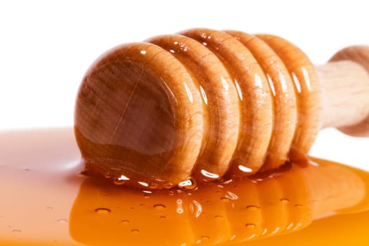 Close-up of a honey spoon in honey