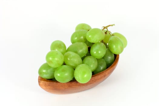 Ripe green grapes in a bowl isolated on white