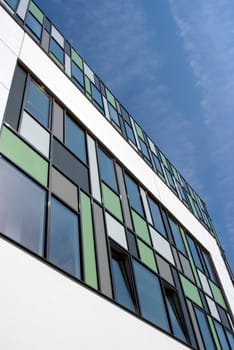colored building with opened windows and blue sky