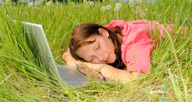 Young woman sleeping on laptop
