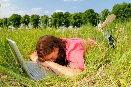 Young woman sleeping on laptop