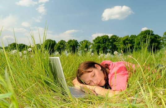 Young woman sleeping on laptop