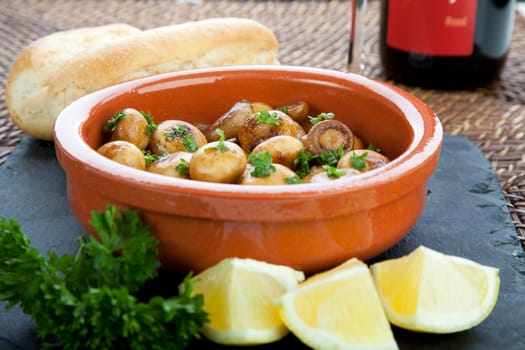 Fresh marinated mushroom tapas with lemon and bread.