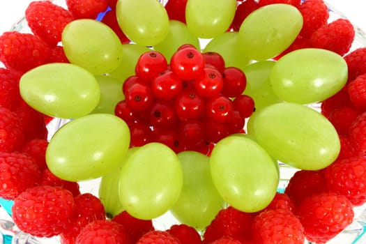 Mix of fruit on the plate isolated on white