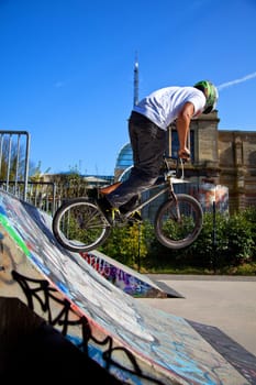 BMX biker performing tricks on a ramp