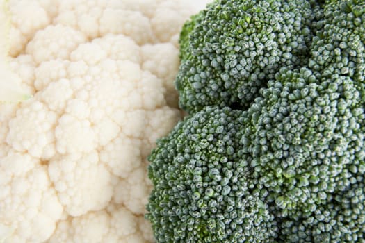 Close-up of fresh raw cauliflower and broccoli.